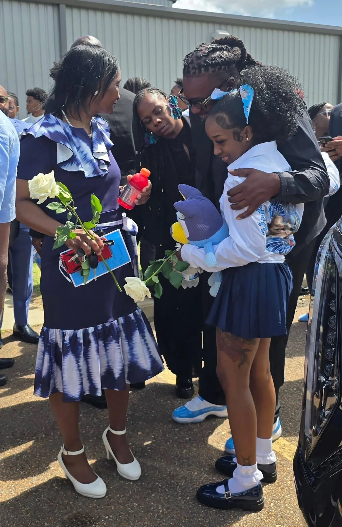 Community members carrying flowers in remembrance of Kohen