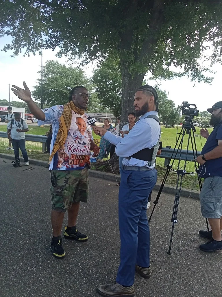 A community spokesperson speaking with a television reporter